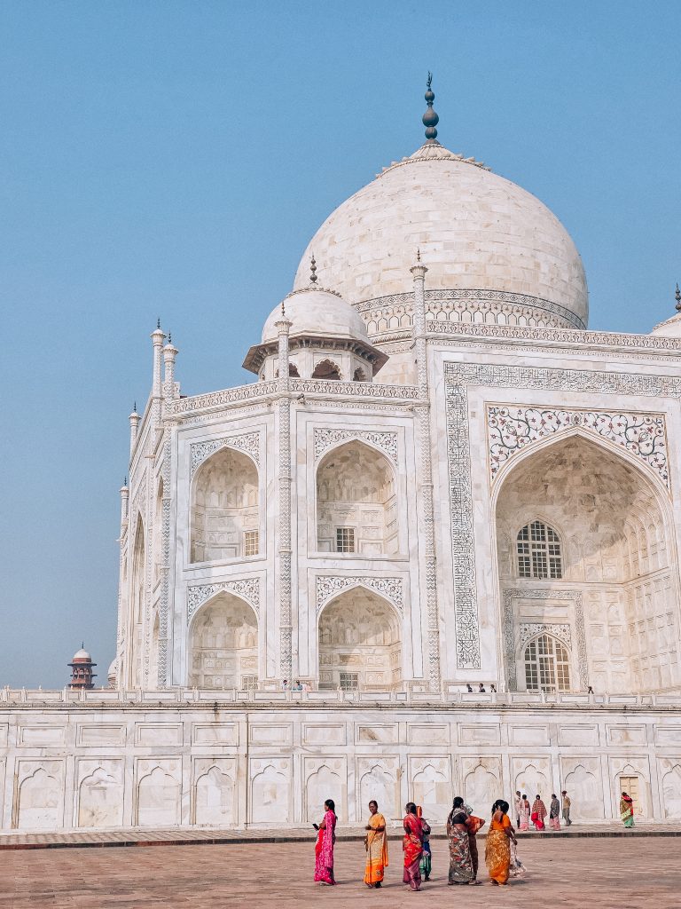 The white marble Taj Mahal reflected in still water at sunrise in Agra, India