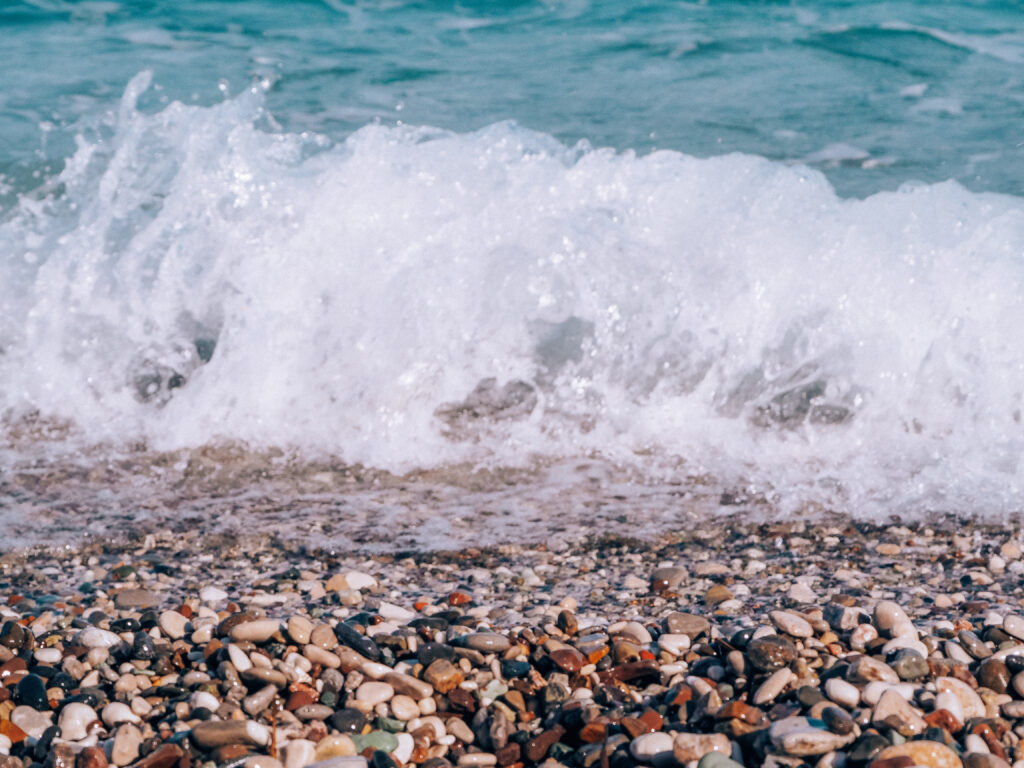 close up of the water and peebles on konyalti beach