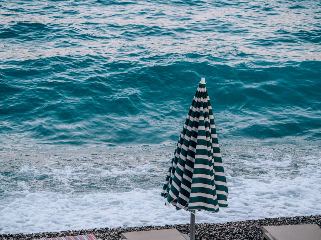 an umbrella on konyalti beach at sunset